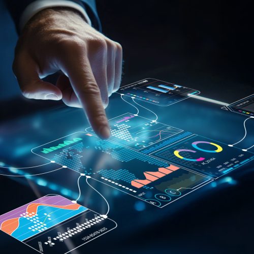 A business professional engages with a modern digital data interface, using hand gestures to interact with charts and metrics in a dark, futuristic setting.